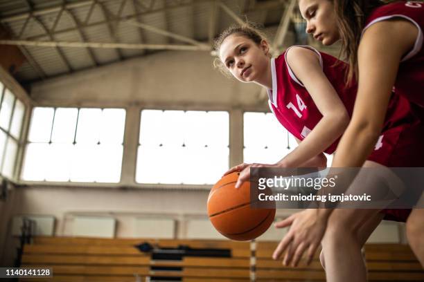 girl defending ball from opponent during match - blocking sports activity stock pictures, royalty-free photos & images