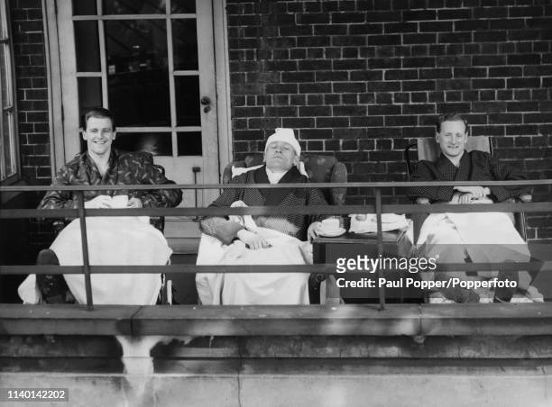 From left, Jimmy Meadows of Manchester City, Bert Trautmann of Manchester City and Tom Finney of Preston North End enjoy the spring sunshine on a...