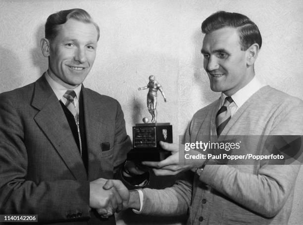 Manchester City footballer Don Revie congratulates his team mate Bert Trautmann on winning the Footballer of the Year trophy on 4th April 1956. Bert...