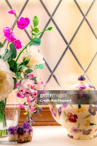 flower and teapot on sheleve - cottage window stock pictures, royalty-free photos & images