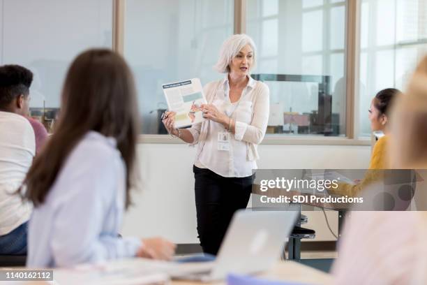 confident mature student teaches a class full of students - back to school flyer stock pictures, royalty-free photos & images
