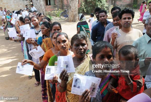 People stand in queues to cast their votes during the fourth phase of Lok Sabha elections, at Mandar on April 29, 2019 in Lohardaga, India. Voting is...