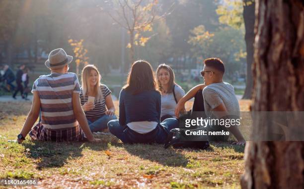 groep van vijf vrienden lachen hardop buiten, het delen van goede en positieve stemming - sociale bijeenkomst stockfoto's en -beelden