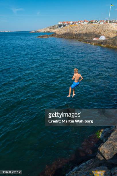 jumping into water - västra götaland county stock pictures, royalty-free photos & images