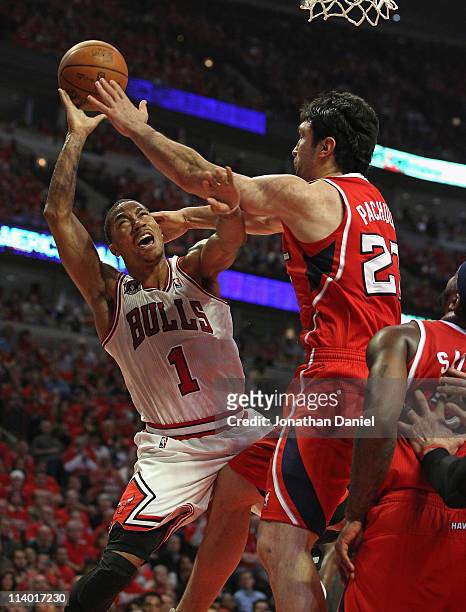 Derrick Rose of the Chicago Bulls is fouled while shooting by Zaza Pachulia of the Atlanta Hawks in Game Five of the Eastern Conference Semifinals in...