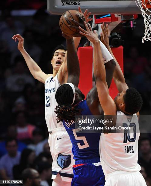 Yuta Watanabe and Ivan Rabb of the Memphis Grizzlies defend a shot by Montrezl Harrell of the Los Angeles Clippers in the game against the Memphis...