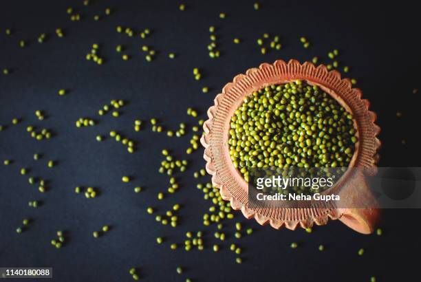 mung bean/green gram in a clay container - mung bean stock pictures, royalty-free photos & images