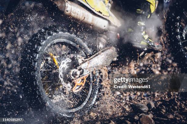 motorcyclist crosses a river with motocross motorcycle - motocross stockfoto's en -beelden
