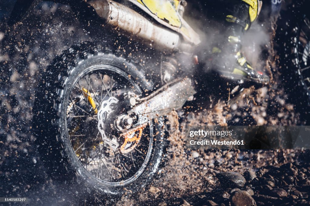 Motorcyclist crosses a river with motocross motorcycle