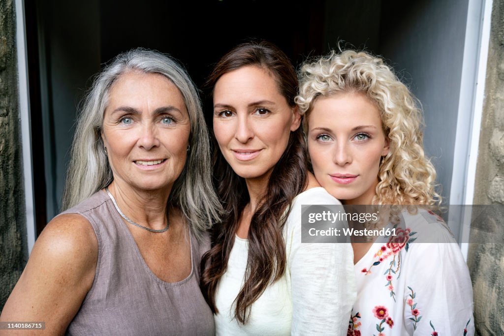 Portrait of three smiling women of different age