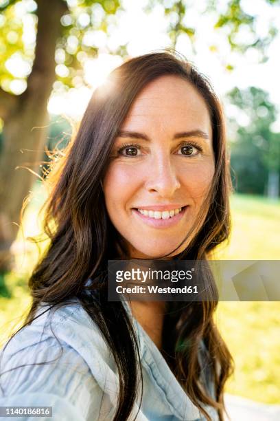 portrait of smiling mature woman in garden - mature woman face beauty stockfoto's en -beelden