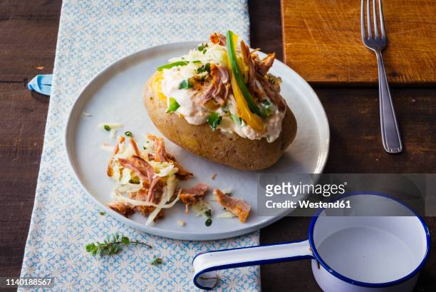 baked potato with curd, sauerkraut, veal and vegetables - jacket potato stock pictures, royalty-free photos & images