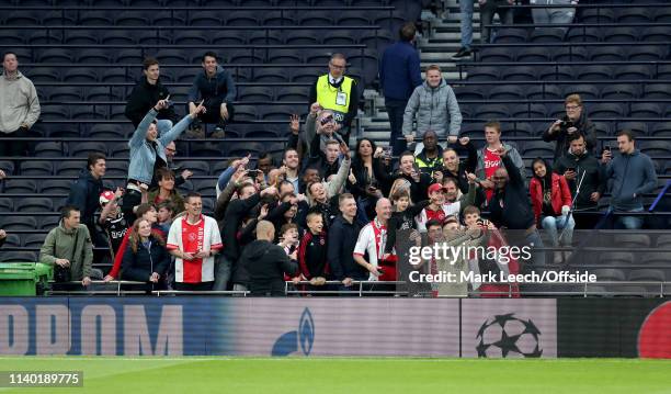 Dusan Tadic takes a selfie with delighted Ajax supporters at the Tottenham Hotspur stadium during AFC Ajax training at Tottenham Hotspur Stadium on...