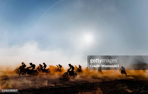 group of motocross motorcycles coming out in the race - dirt bike stock pictures, royalty-free photos & images