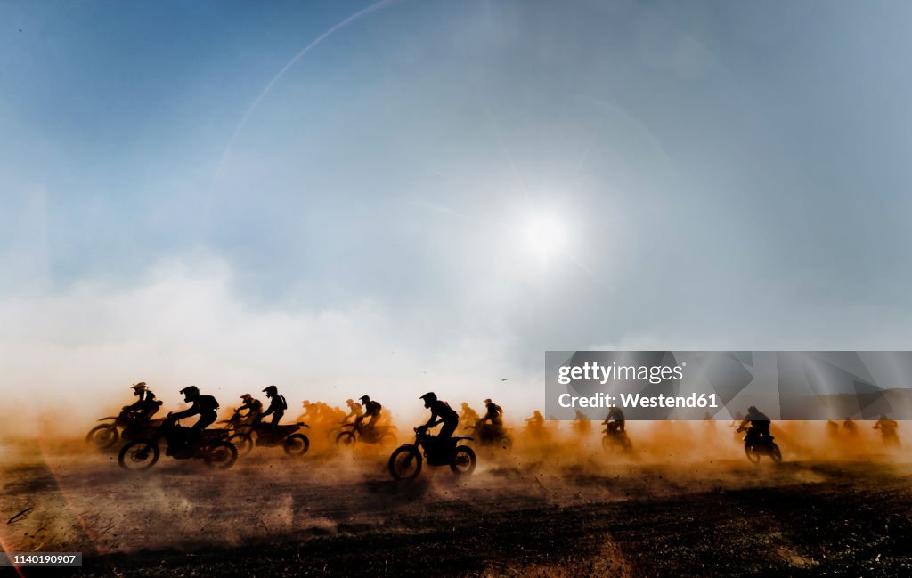 Group of motocross motorcycles coming out in the race