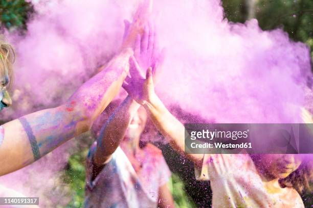 people celebrating holi, festival of colors - vernice in polvere foto e immagini stock