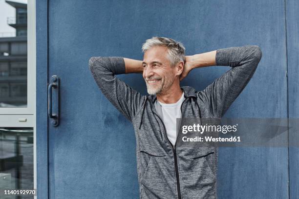 portrait of laughing mature man in front of gym - hands behind head stock pictures, royalty-free photos & images