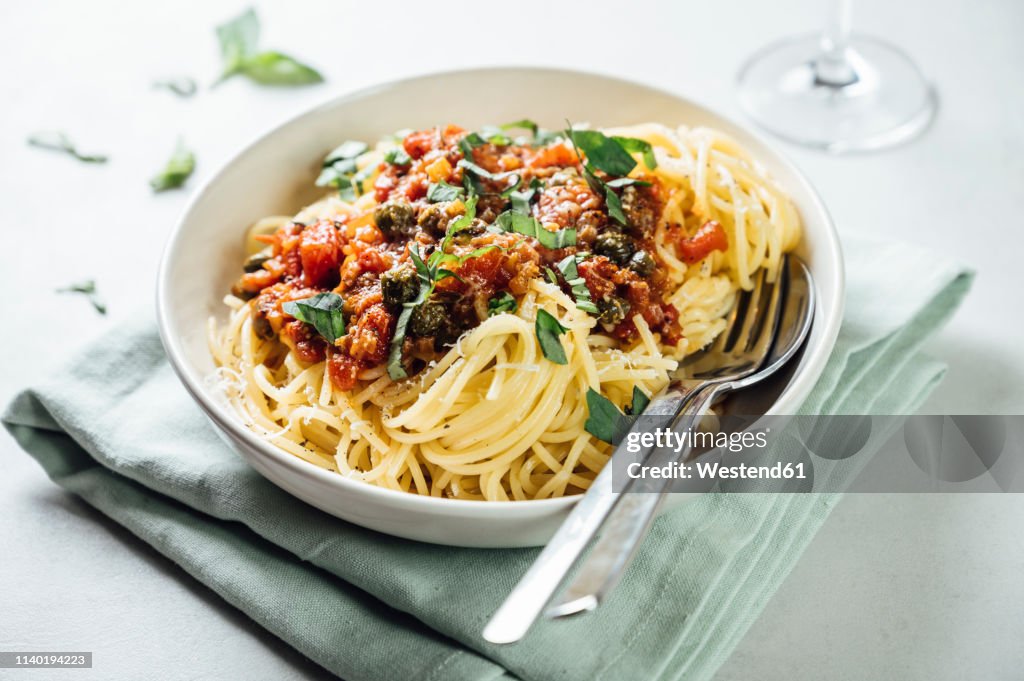 Spaghetti with tomato caper sauce, basil and parmesan