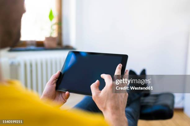 close-up of man using tablet at home - man hand ipad stock pictures, royalty-free photos & images