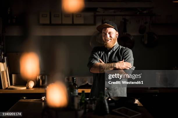 proud hobby chef standing in his kitchen, with arms crossed - chef male kitchen stock pictures, royalty-free photos & images