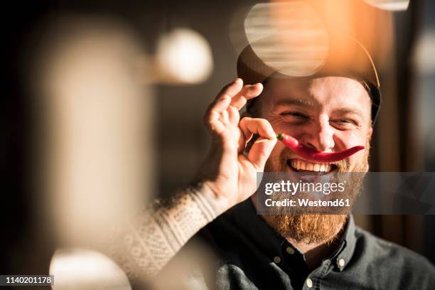 portrait of a man with a red chili moustache - personal chef stock pictures, royalty-free photos & images