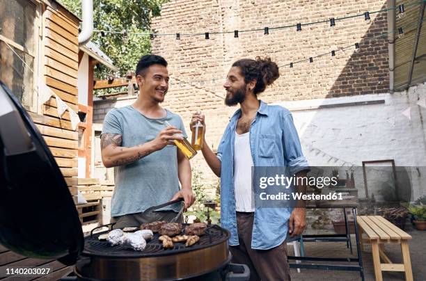 friends preparing meat for a barbecue in the backyard - grill friends and beer stock pictures, royalty-free photos & images