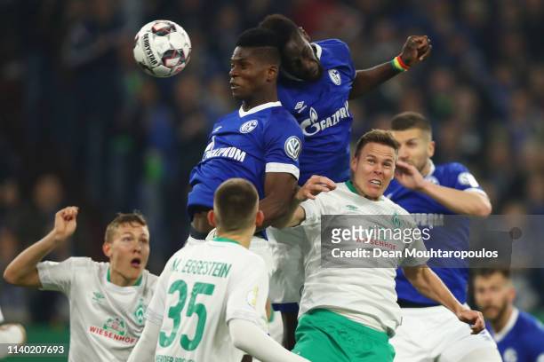 Niklas Moisander of Bremen jumps for a header with Salif Sane and Breel Embolo of Schalke during the DFB Cup quarterfinal match between FC Schalke 04...