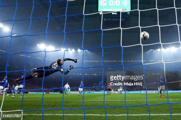 Milot Rashica of Bremen scores his team's first goal against goalkeeper Alexander Nuebel of Schalke during the DFB Cup quarterfinal match between FC...