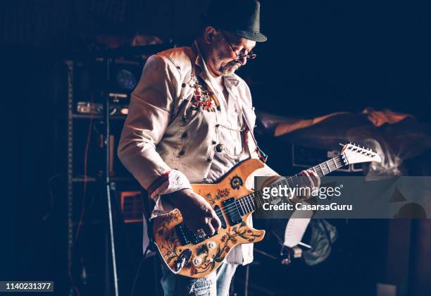 senior rock guitarist practicing - rock star stock pictures, royalty-free photos & images
