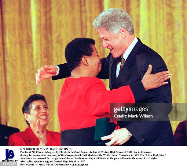 President Bill Clinton is hugged by Elizabeth Eckford, former student of Central High School of Little Rock, Arkansas, during the presentation...
