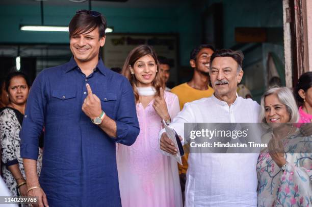 Bollywood actor Vivek Oberoi, his wife Priyanka Alva Oberoi, father Suresh Oberoi and mother Yashodhara pose for camera after casting their votes in...