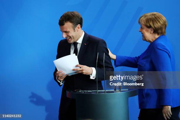 Emmanuel Macron, France's president, left, and Angela Merkel, Germany's chancellor, depart after delivering statements ahead of the Balkan summit at...
