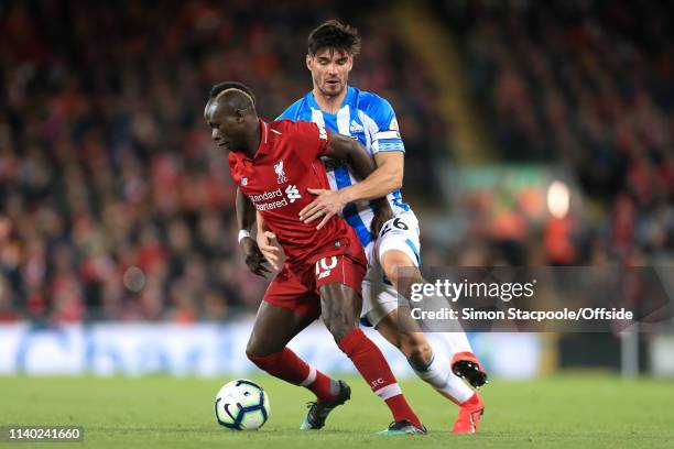 Sadio Mane of Liverpool battles with Christopher Schindler of Huddersfield during the Premier League match between Liverpool and Huddersfield Town at...