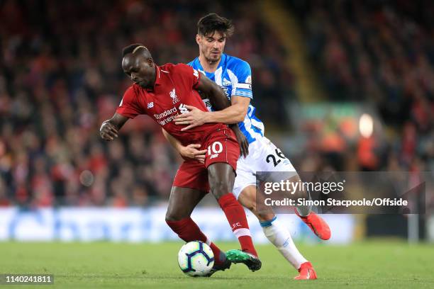 Sadio Mane of Liverpool battles with Christopher Schindler of Huddersfield during the Premier League match between Liverpool and Huddersfield Town at...