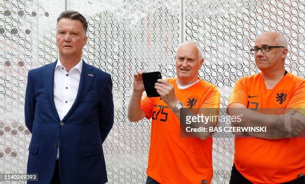 Former Manchester United's head coach Louis van Gaal , flanked by two football fans attends the unveiling of the Oranje Wall of Fame at the KNVB...