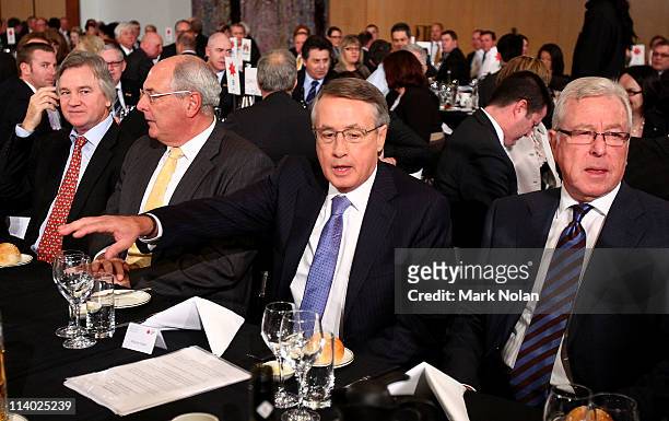 Treasurer Wayne Swan is seated before he delivers his fourth annual post-budget address to the media at Parliament House on May 11, 2011 in Canberra,...