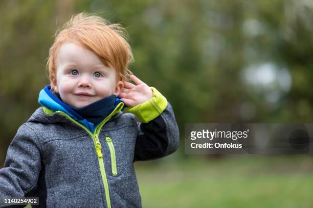 il bambino che ascolta la natura suona all'aperto - soltanto un neonato maschio foto e immagini stock