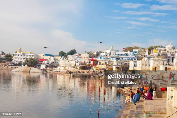 people visiting the holy lake of pushkar, india - pushkar stock pictures, royalty-free photos & images