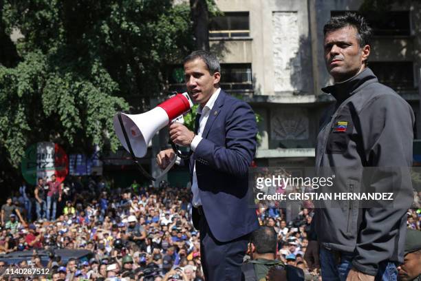 Venezuelan opposition leader and self-proclaimed acting president Juan Guaido speaks to supporters next to high-profile opposition politician...