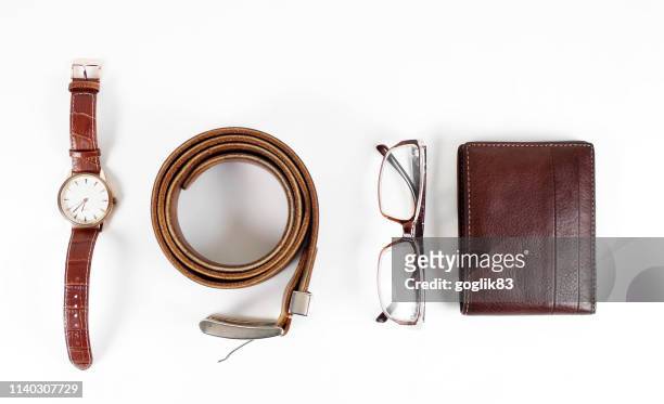 high angle view of personal accessories against white background - belt stock pictures, royalty-free photos & images
