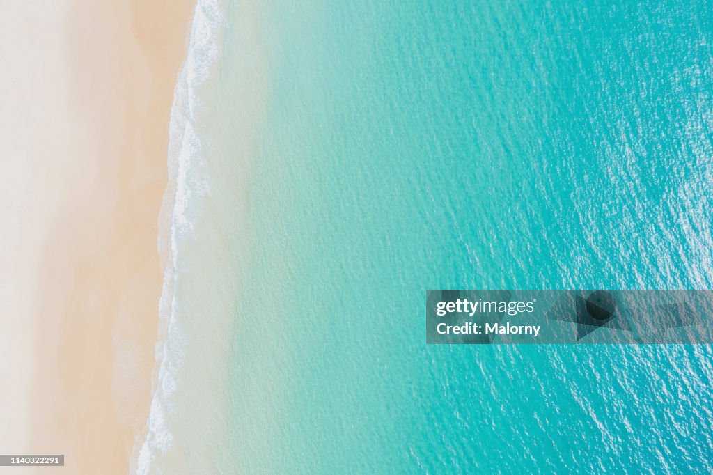 Aerial view on empty beach and turquoise sea. Directly above. Drone view.