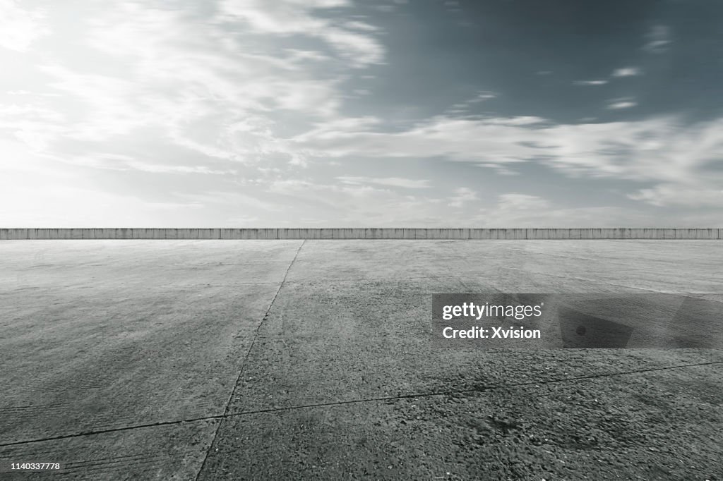 Wide open concrete platform under blue sky