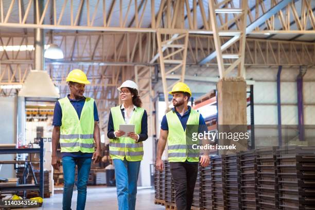 manager discussing with trainees in factory - visit stock pictures, royalty-free photos & images