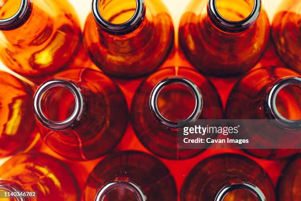 session of empty and brown glass bottles for advertising photographs - brown bottle stock pictures, royalty-free photos & images