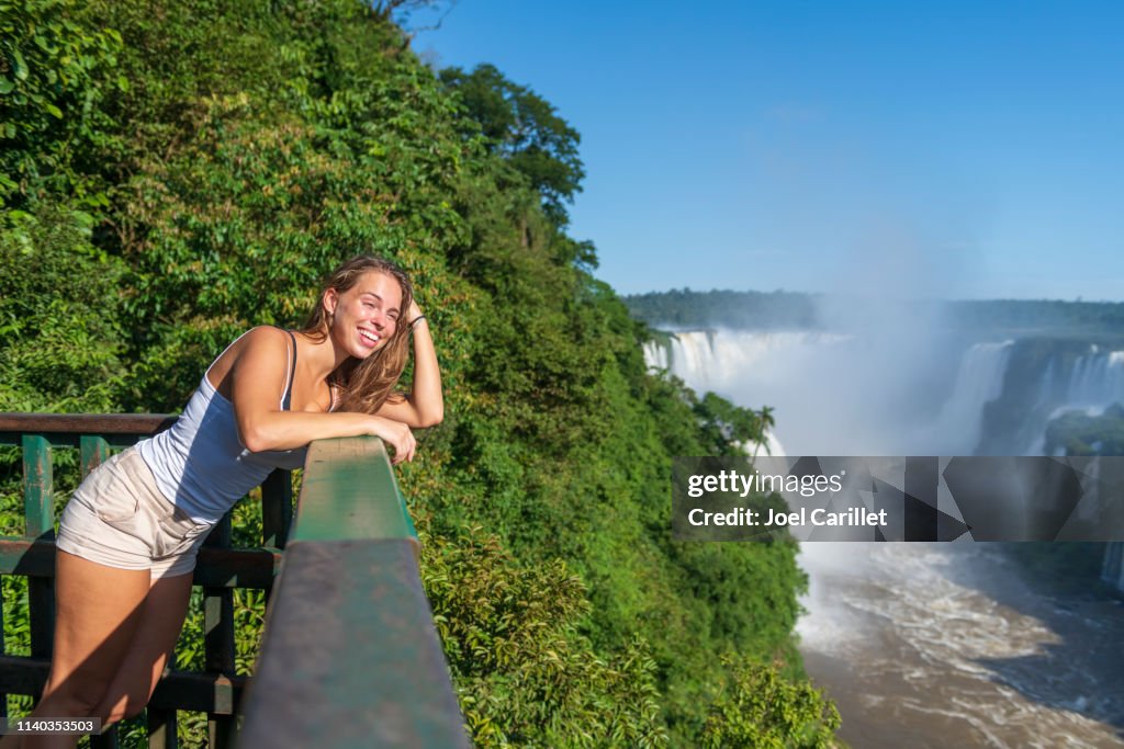 Young woman visiting Iguazu Falls in Brazil