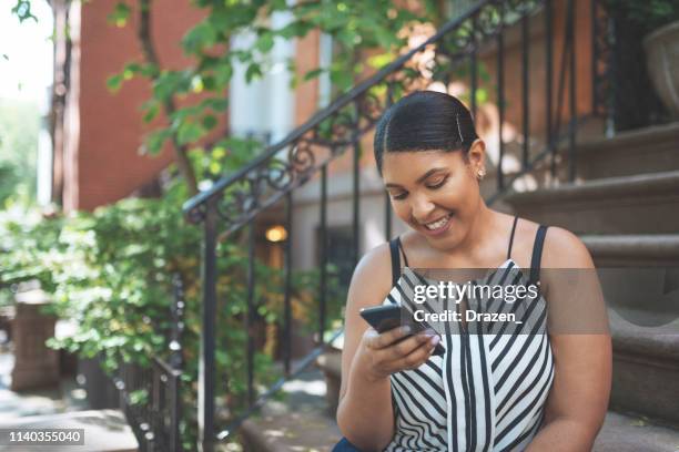 beautiful plus size dominican woman in usa using phone for communication. - dominican ethnicity stock pictures, royalty-free photos & images