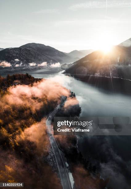 clouds over lake in germany - lenggries stock-fotos und bilder