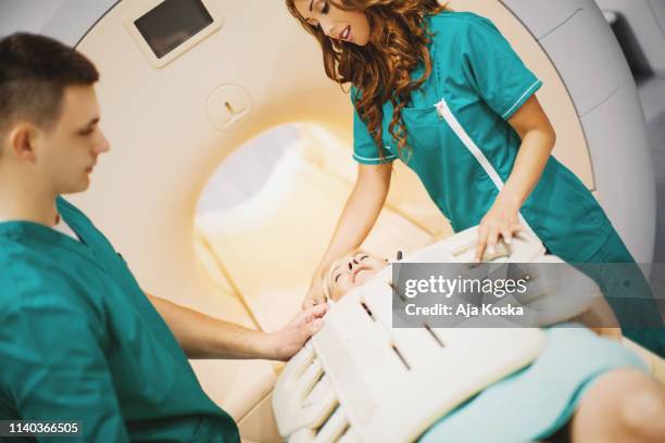preparing patient for mri scan. - mri abdomen stock pictures, royalty-free photos & images