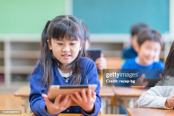 elementary school students studying in classroom - asian-students-classroom-computer stock pictures, royalty-free photos & images