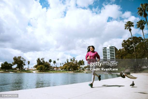 woman exercising in los angeles city park - los angeles park stock pictures, royalty-free photos & images